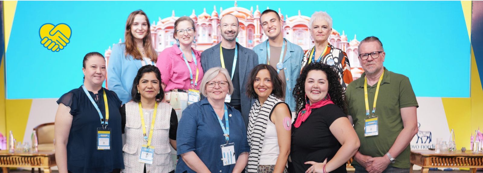 A group of people, all many races and heights, smiling at a camera. They are on stage at the End Diabetes Stigma Summit.