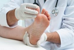 A doctor inspecting a foot