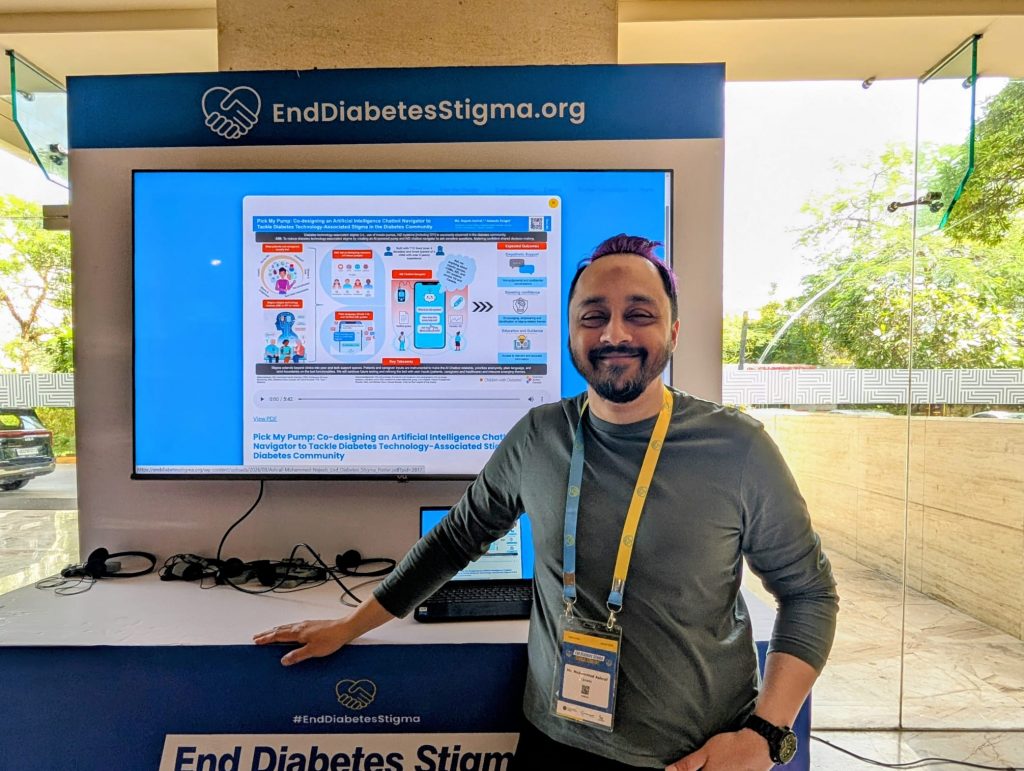 Najeeb stands in front of his AI Chat Bot project and smiles at the camera. 